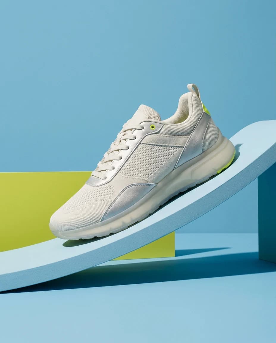 Silver and ivory sneaker on a sky blue and chartreuse sculptural ramp